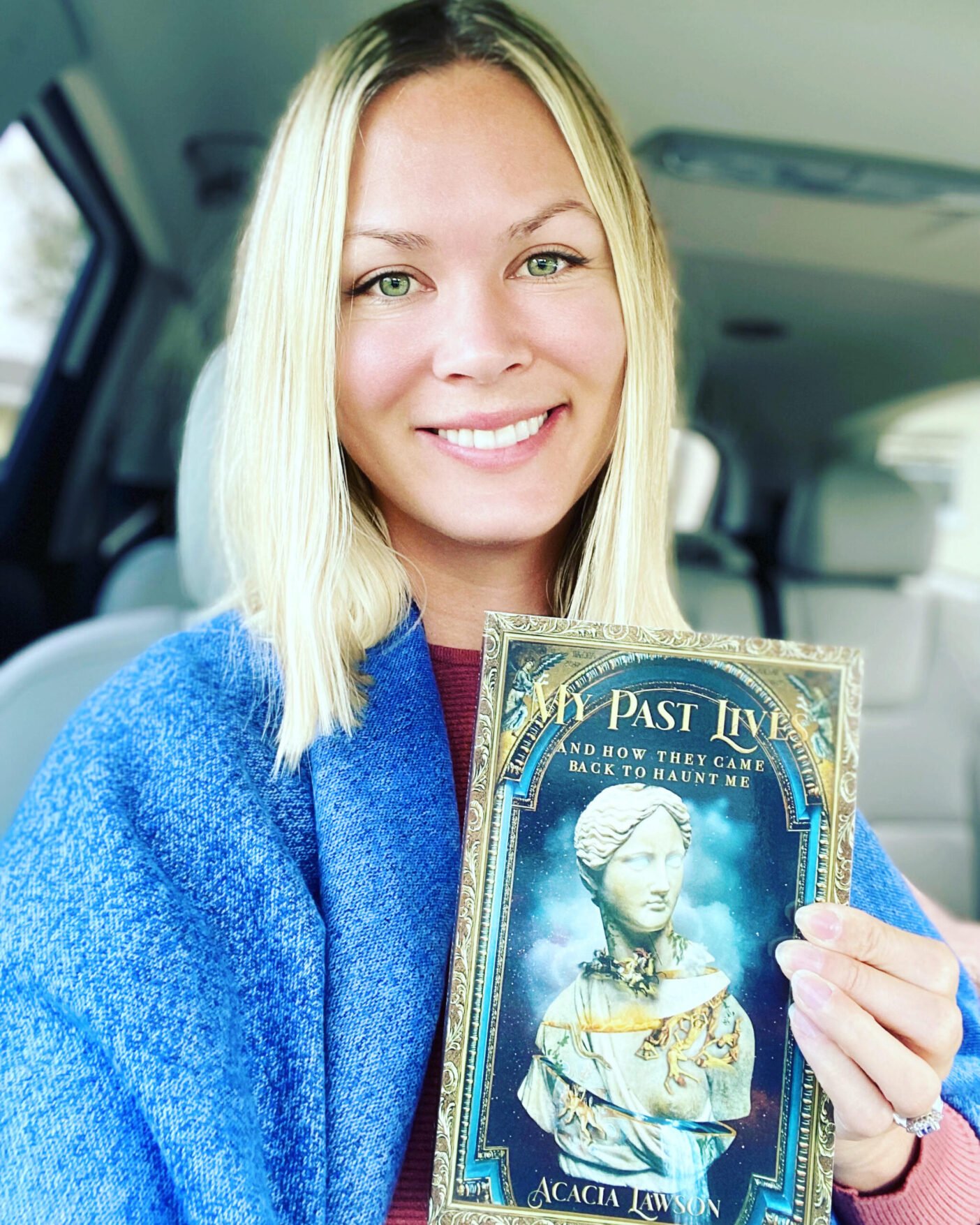 Acacia Lawson holding her book 'My Past Lives'